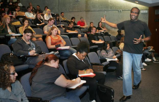 Nursing student Austin Nation talks to students in a tiered classroom.