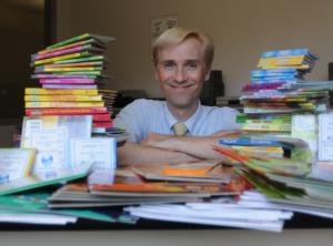 Librarian John Hickok surrounded by children's books