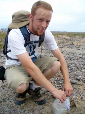 student Bryan White collects samples of the Mohave Desert