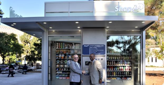 Frank Mumford and Ron Campbell infront of automated store.