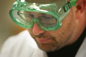 close-up of high school instructor Charles Bushman's face with safety goggles.