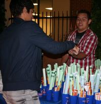 A student is handed a free goodie bag during All-Night Study at the Titan Student Union.