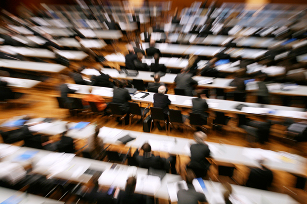 Blurred image of many tables of people planning