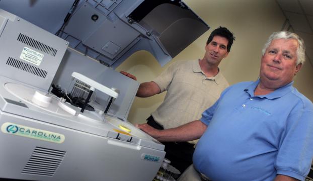 Ron Morley and James Henneman with lab equipment