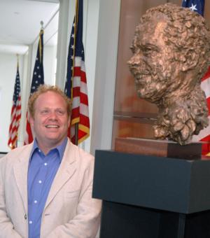 Scott Spitzer looks up at a bronze bust of Richard Nixon