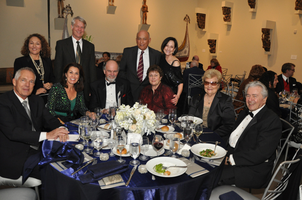 faculty and staff of the College of Communications gather around one of the tables at the gala.