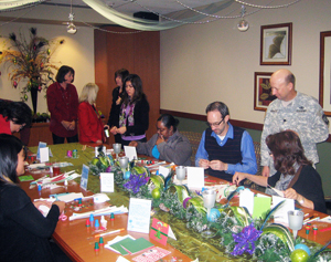 people making cards in a holiday decorated room.