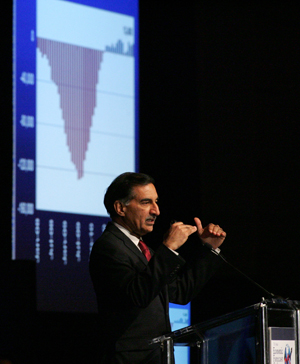 Anil Puri speaks at a podium during the annual economic forecast.