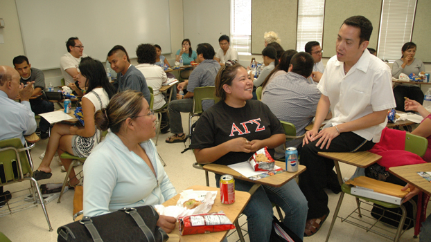 Alexandro Gradilla, at right, talks to Hispanic students.