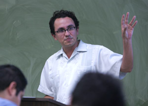 Gustavo Arellano gestures as he addresses a class of students.