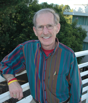 Ben Hubbard stands beside railing outside University Hall.