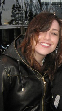 Dark-haired Kaylin Warren wearing a black leather jacket.