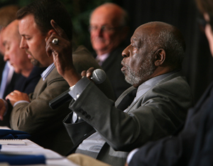 Photo of committee members responding to questions.