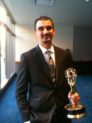 Brent Steinberg holding his Emmy Award.
