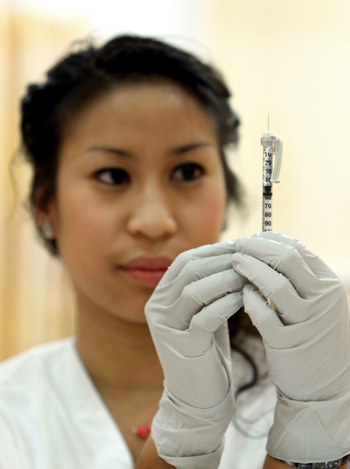 NURSING STUDENT WITH SYRINGE