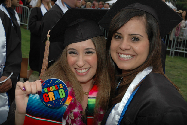 Two 2009 graduates are all smiles during the ceremony.