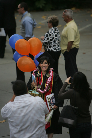 Proud parents take a photo of their graduate.