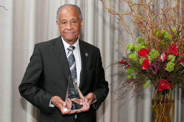 President Milton A. Gordon holds award presented to him by his alma mater.