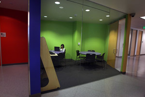 A student studies in one of brightly painted study rooms.