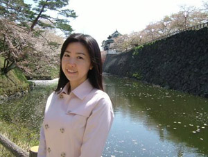 International student Yuki Abe Jourdan standing before a river .