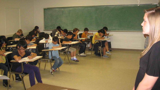 Group of high school students taking a test.
