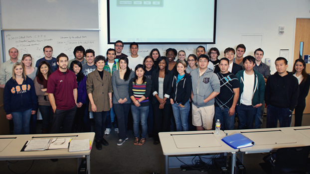 Mabel Kung stands among students from one of her classes.