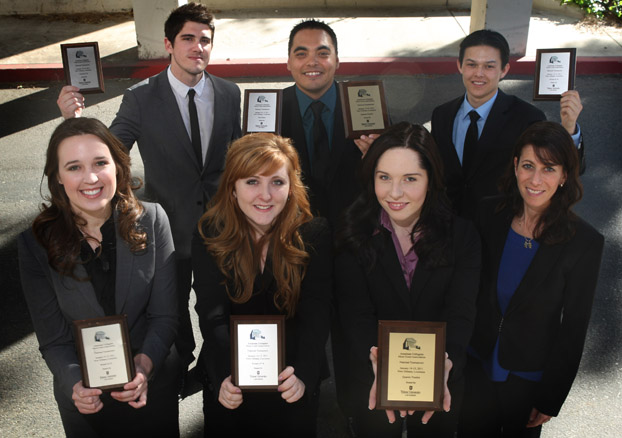 The six winners of a recent competition surround their adviser Pamela Fiber-Ostrow.