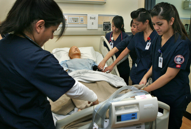 Nursing student practice over a mechanical ‘patient.’