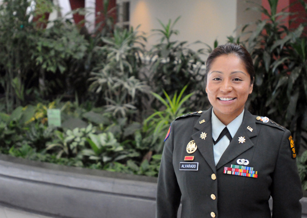 Alejandra Alvarado, wearing her dress uniform, stands infront of a planter in the Atrium Gallery of the Titan Student Union.