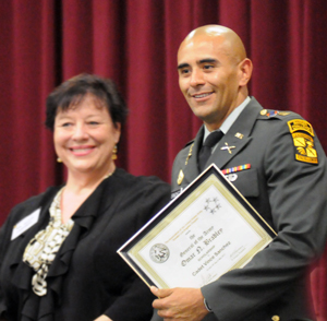 Victor Sanchez, in uniform, stands with Felicia Campbell.