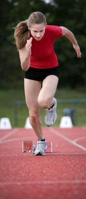 a female runner along a stadium track.