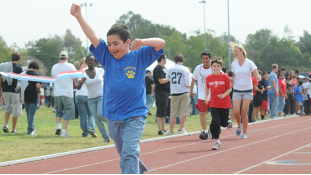 A child shares the joy of winning a race during the 2009 special games.