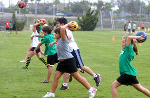 Children practice soccer throws during the 2007 summer camp.