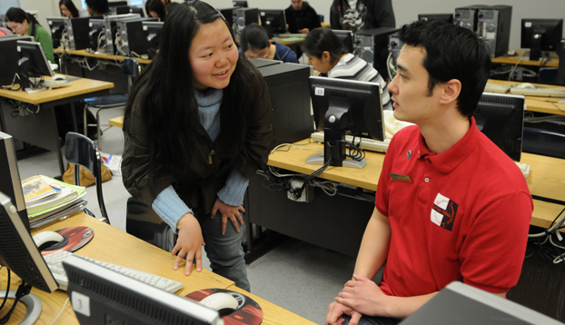 business students Daisy Zhao and Anthony Kress confer about the VITA program.
