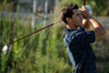 photo of a golfer looking up after taking a swing.