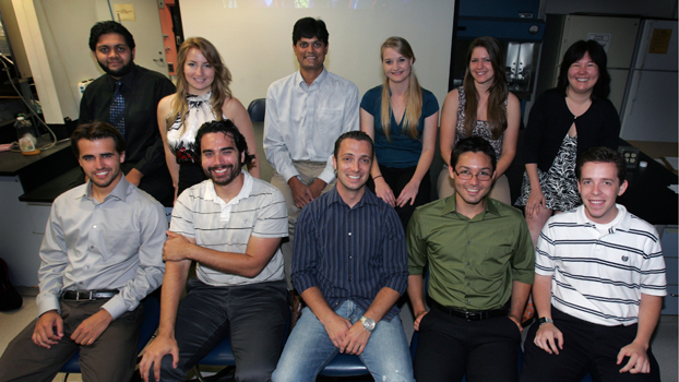 Nine students and two faculty sitting in two rows.