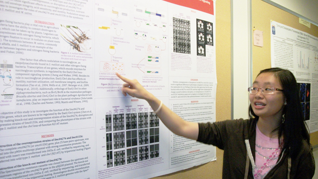 Tran Trinh points to the poster on her summer research.