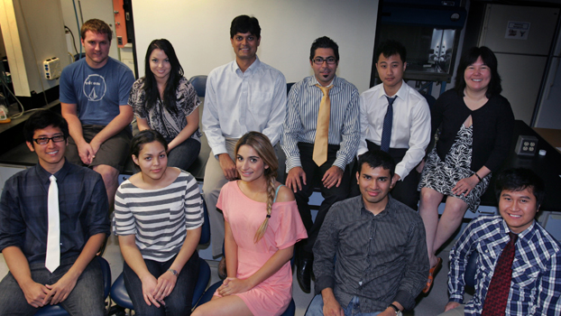 Nine students and two faculty sitting in two rows.