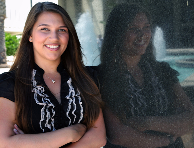 Jacqueline Kamel stands beside marble sign in front of Langsdorf Hall.