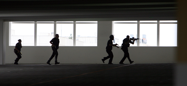 Four police officers check out the parking structure as part of exercise.