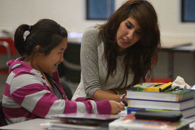 A Project MISS tutor works with one of her young charges.