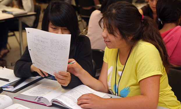 Two Project MISS students look over a math problem.