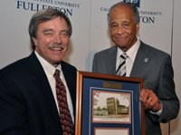 President Milton A. Gordon hands a plaque to Larry Ward.