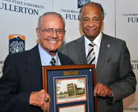 Vuryl Klassen, holding a plaque, and President Milton A. Gordon 