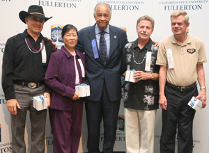 Four veteran staff members pose with President Gordon.