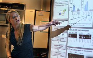 woman uses a pointer while making a presentation