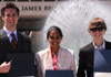 three students standing before a fountain