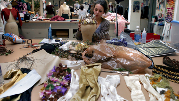 a woman works in a costume shop.