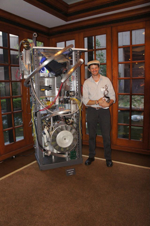 young man with his sculpture of a giant box made up of electronic components