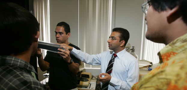 Kiran George surrounded by students